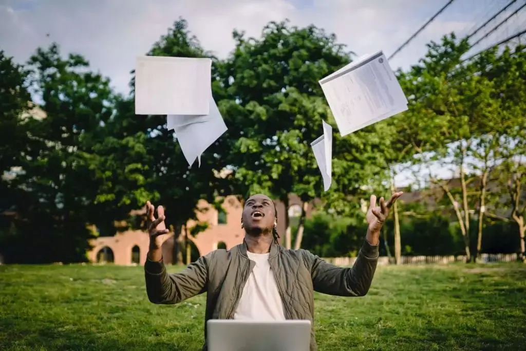 Study tips for working professionnals : Man throwing papers