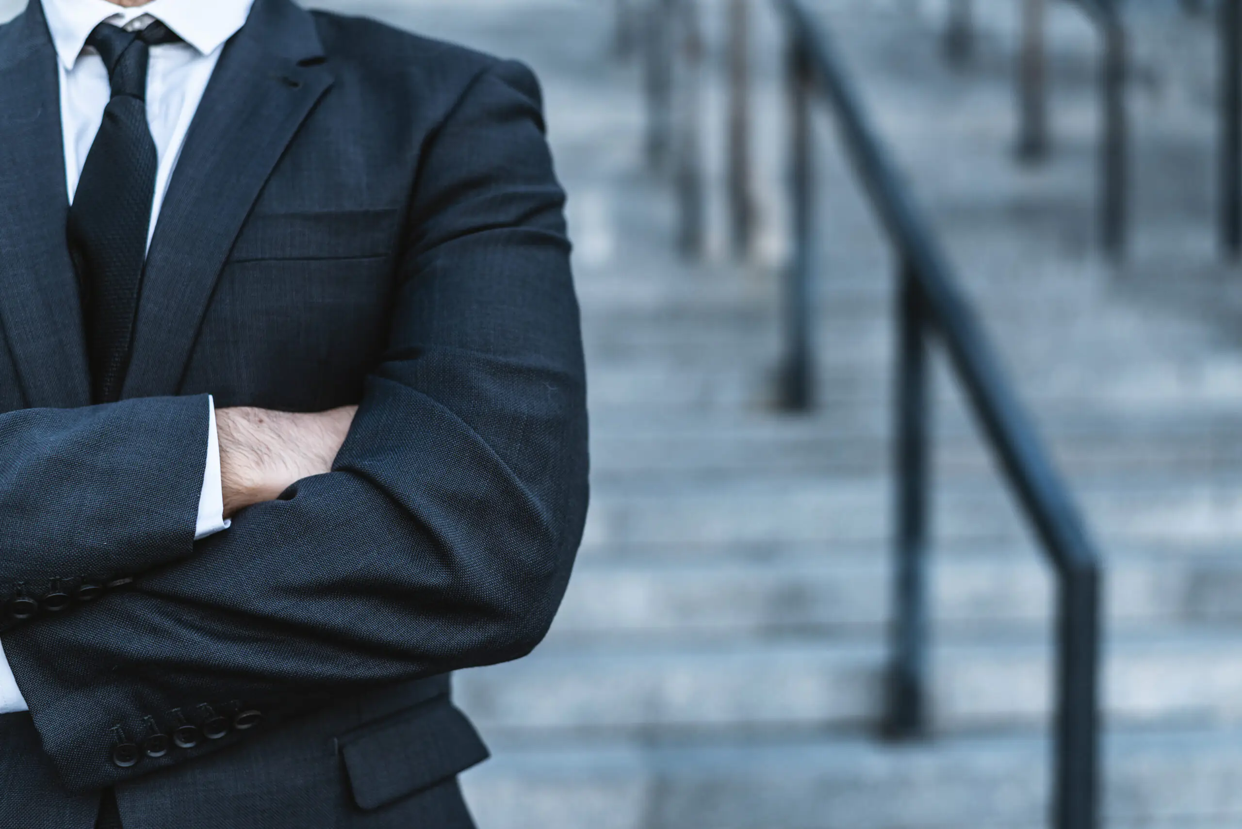 Close-up businessman crossing his hands posing against the back