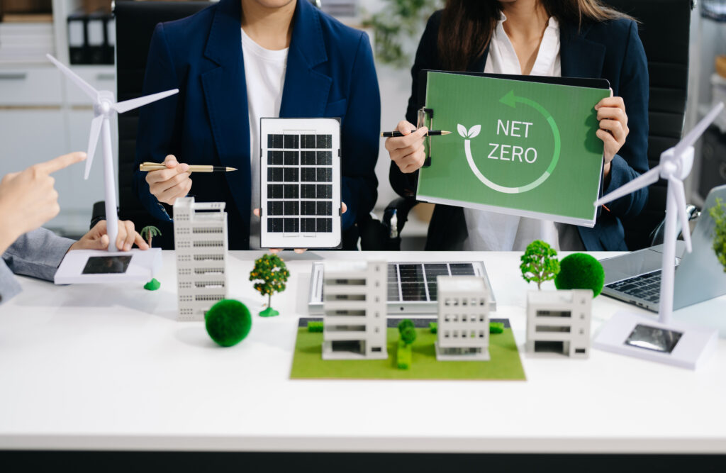 Business team people planning hand using laptop for working technology and business Net zero and carbon neutral concept.NET ZERO icons and symbols save the eco world and reduce pollution. green energy