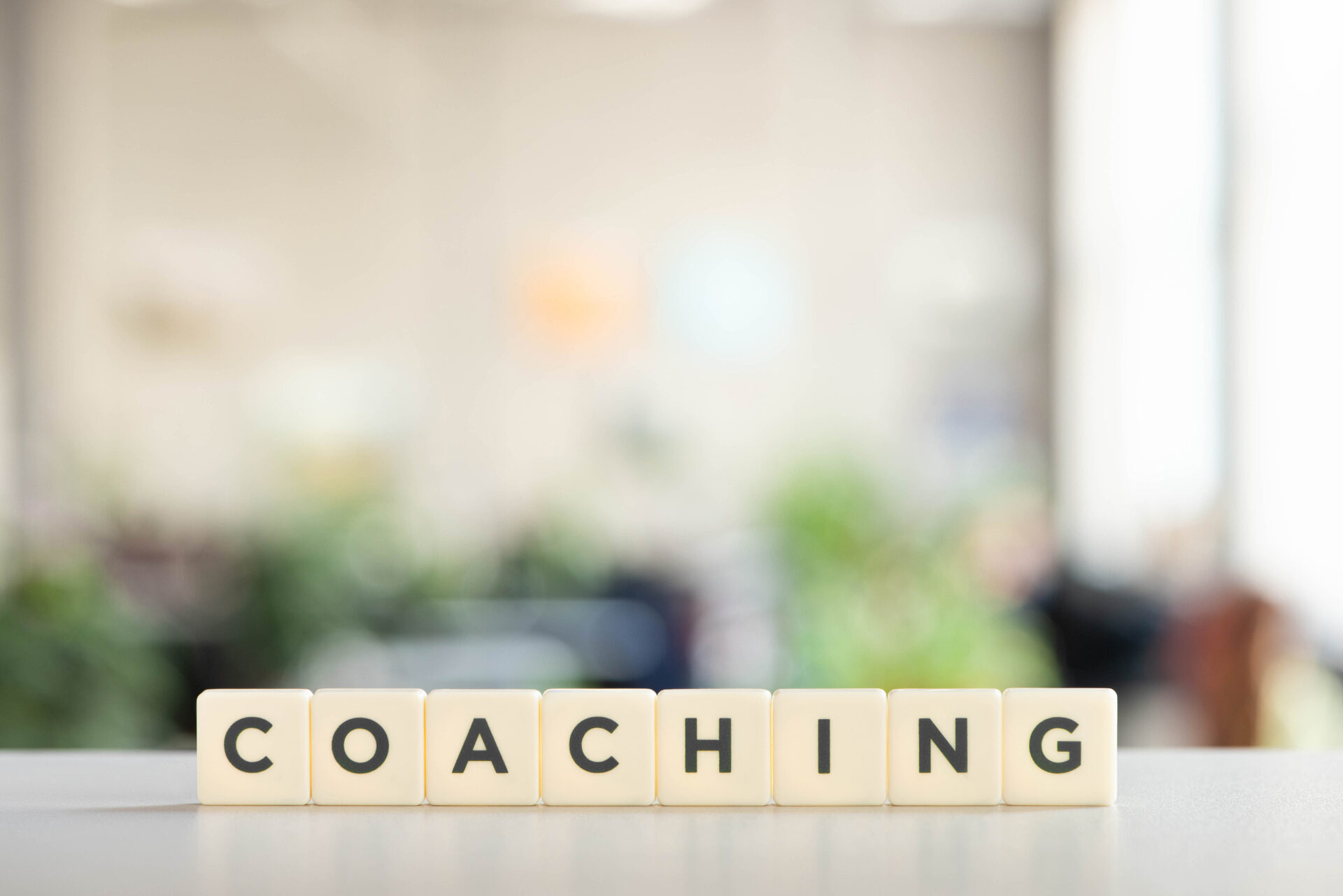 white cubes with coaching inscription on white desk