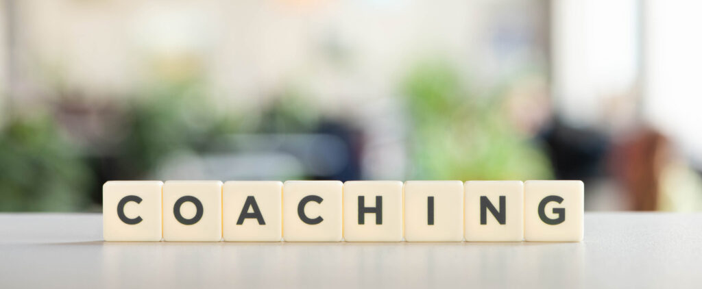 white cubes with coaching inscription on white desk