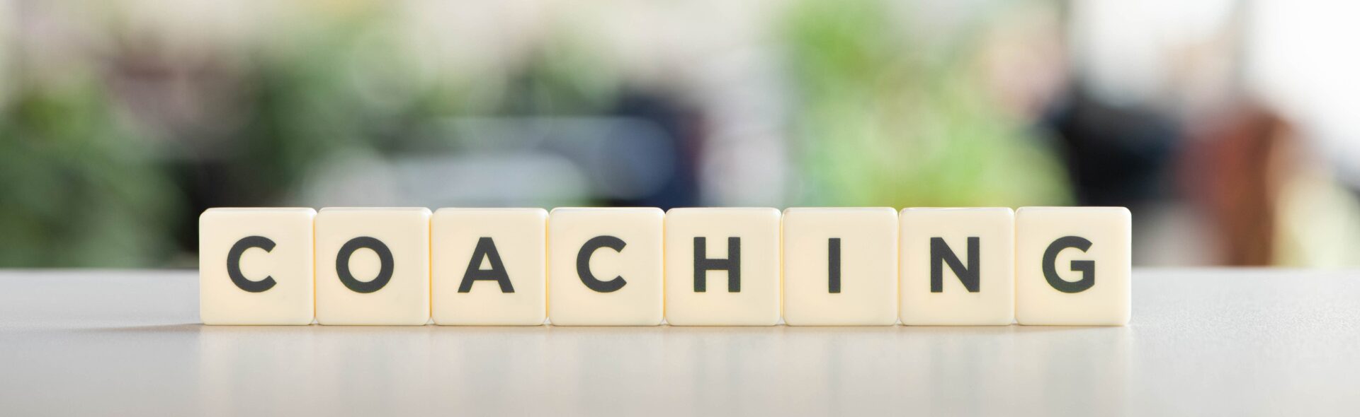 white cubes with coaching inscription on white desk