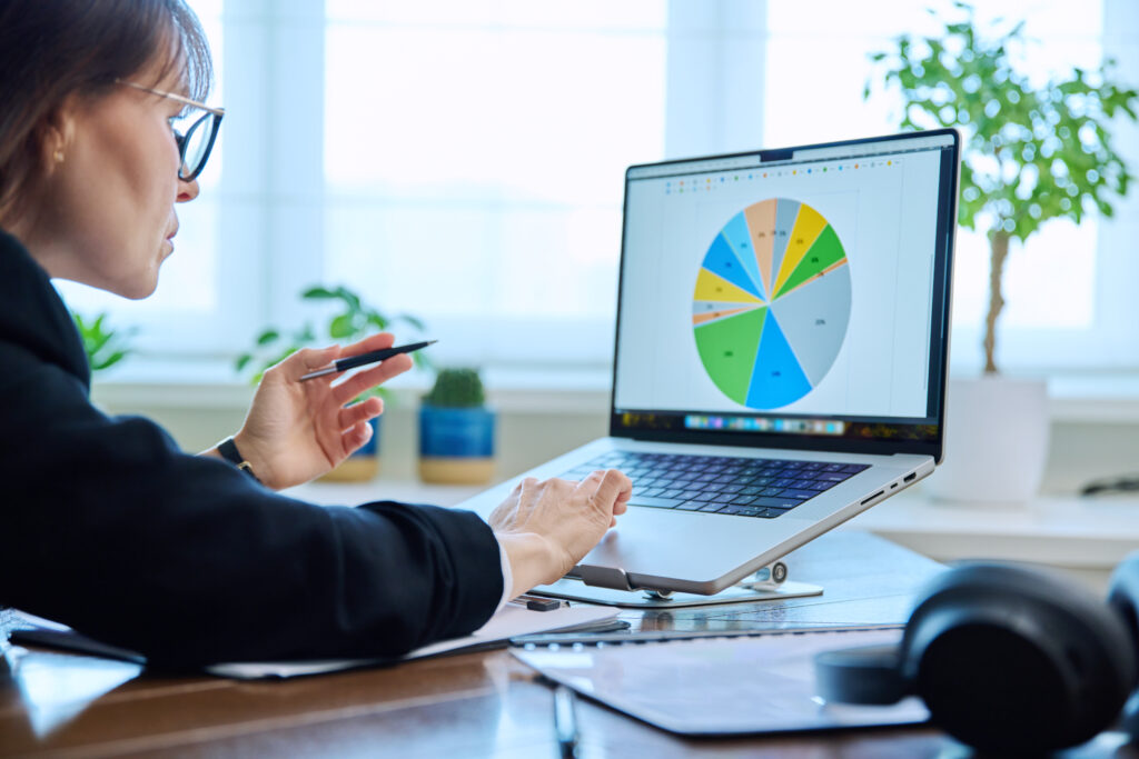 Mature serious business woman working at computer, workplace boss entrepreneur