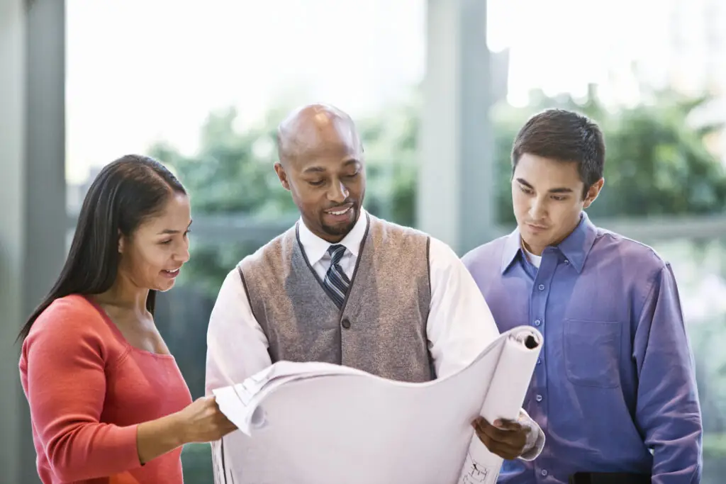 Mixed race team of business people at a table in a business center.