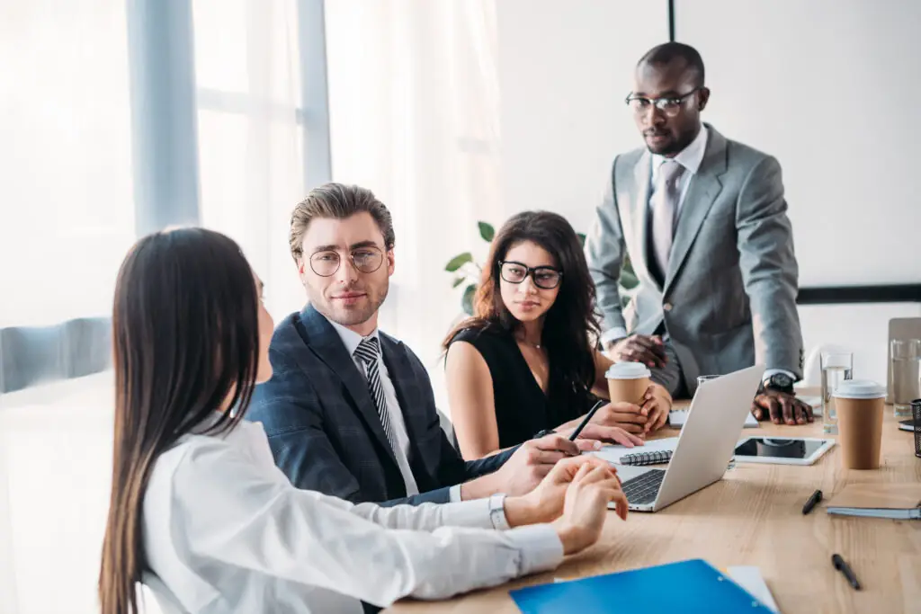 selective focus of multicultural business people having business meeting in office