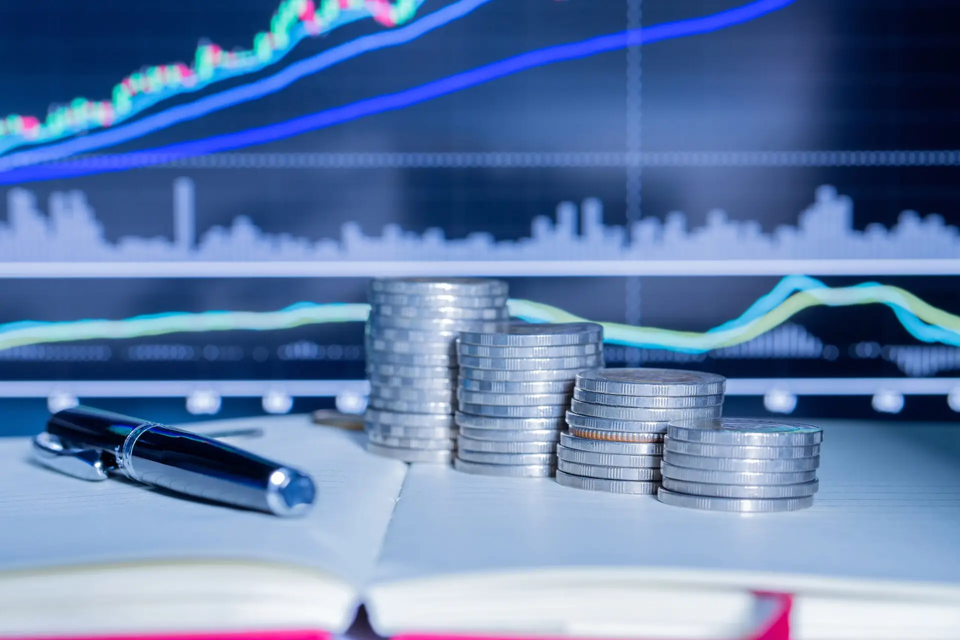 stack-money-coin-with-trading-graph-scaled