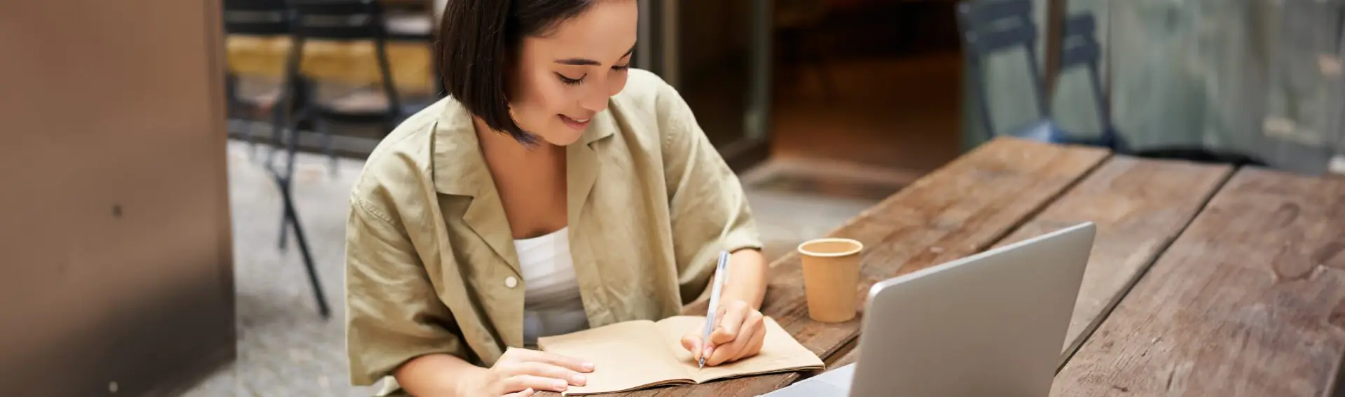 portrait-young-asian-woman-working-laptop-making-notes-writing-down-while-attending-online