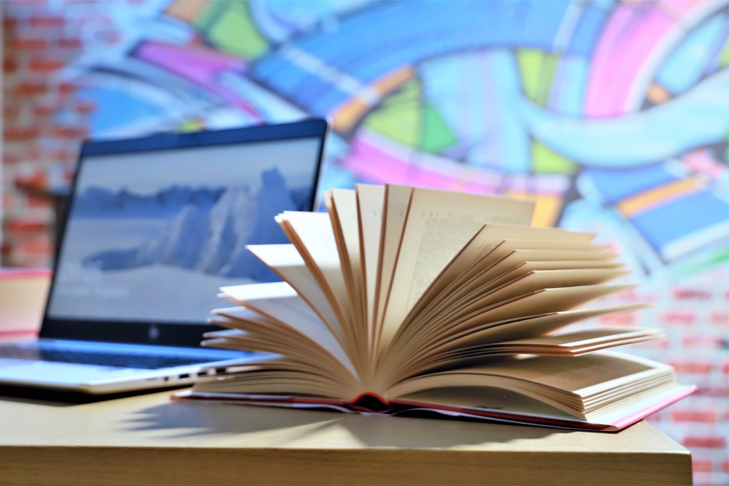 close-up-of-a-fanned-book-with-computer-2026-01-07-02-04-20-utc