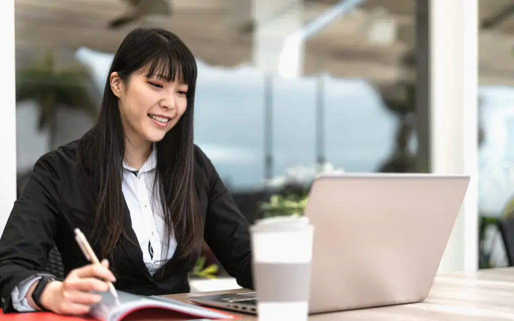 Business Asian woman working on laptop in cafe shop - Youth entr