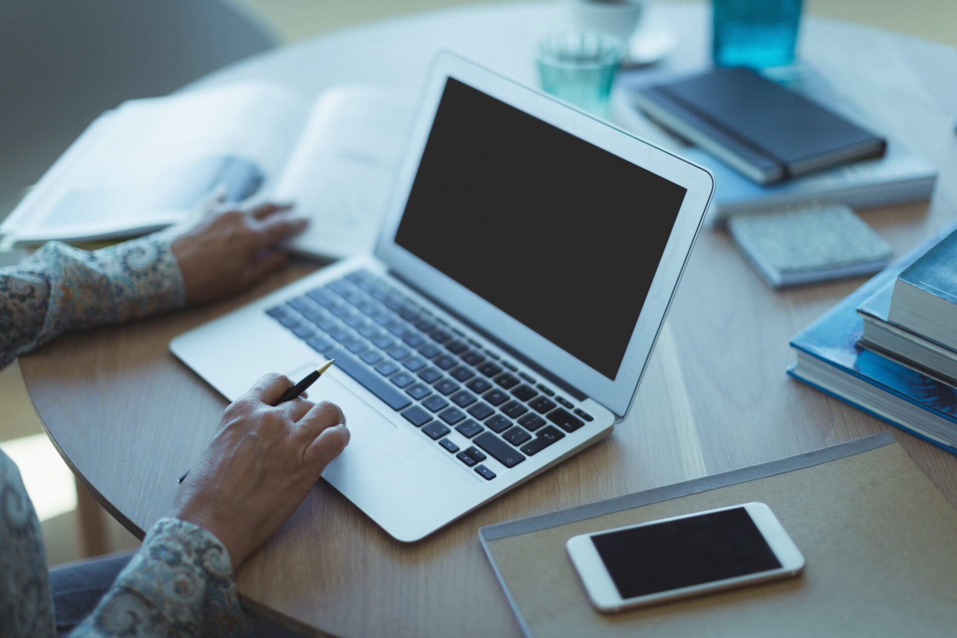 High angle view of businesswoman using laptop while sitting at table in office