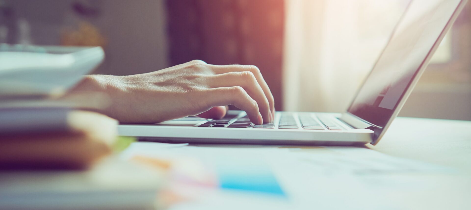 hands-typing-on-a-laptop-in-bright-sunlight-2026-03-17-00-42-00-utc
